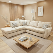 Beige sectional sofa in a living room with a wooden coffee table and decorative items.