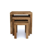 A set of three square nesting tables made of natural mango wood, with visible grain and textures, stacked together.