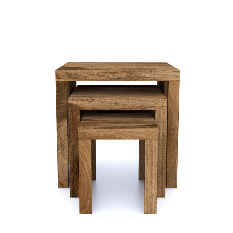 A set of three square nesting tables made of natural mango wood, with visible grain and textures, stacked together.